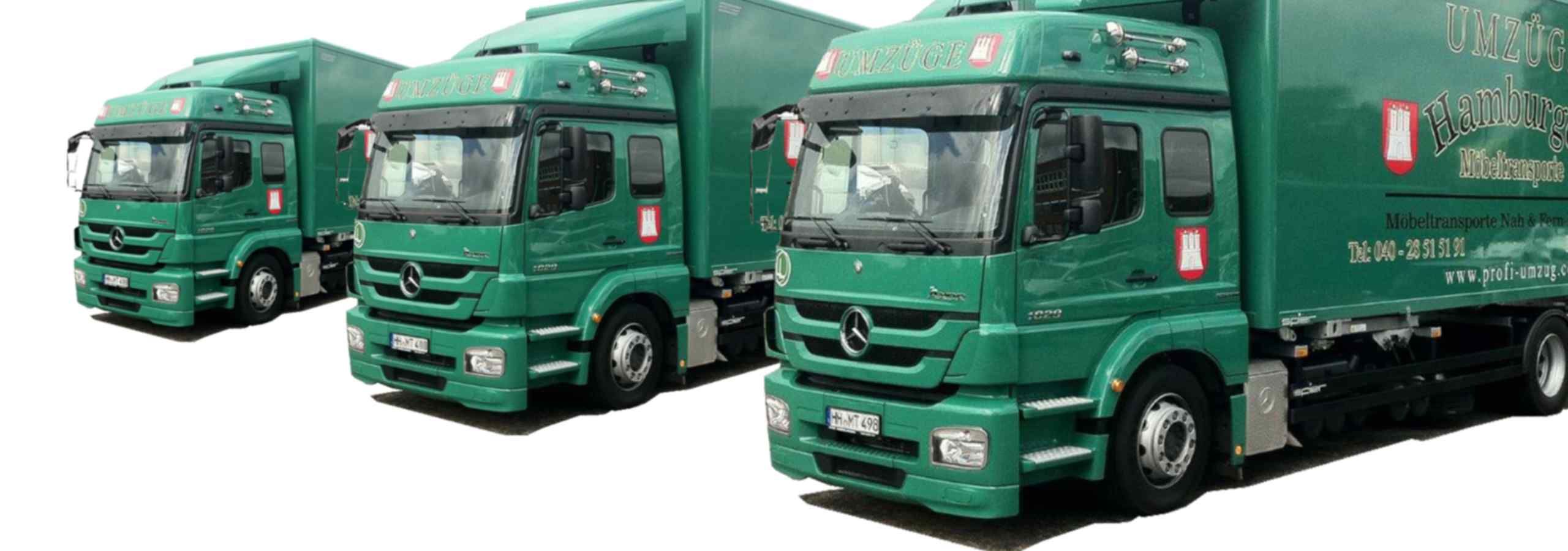 Drei LKWs von Hamburger Möbeltransporte nebeneinander